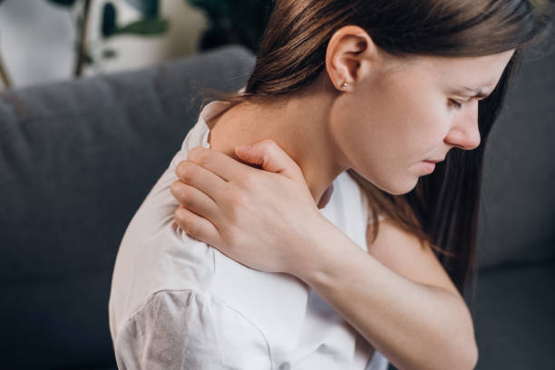 Closeup young woman shoulders in tight top leaning on small ball against  wall to fix back ache, massaging stiff muscles and sore neck, exercise to  rel Stock Photo - Alamy