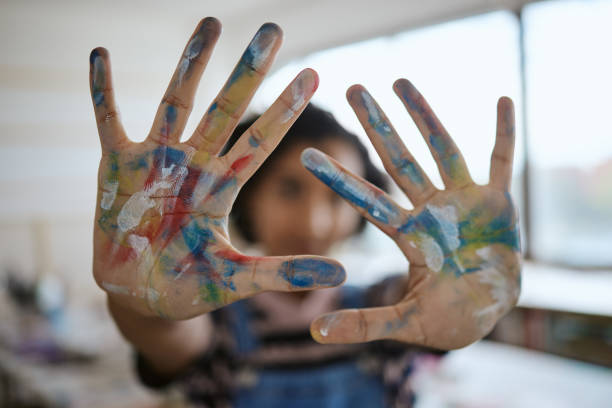 istock Hands, paint and art with a woman creative artist or painter having fun in her studio or design workshop. Palm, color and artistic with a female working in a classroom or gallery for creativity 1442606339