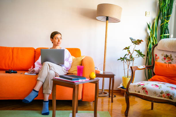istock Young woman working on laptop at home 1442608643