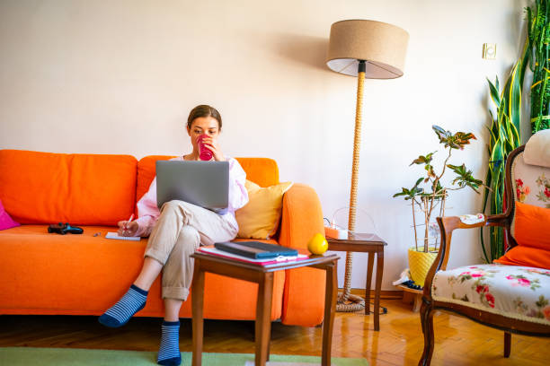 istock Young woman working on laptop at home 1442608649