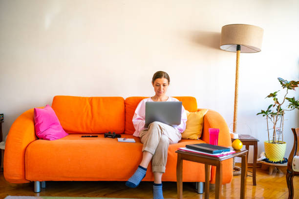 Young woman working on laptop at home