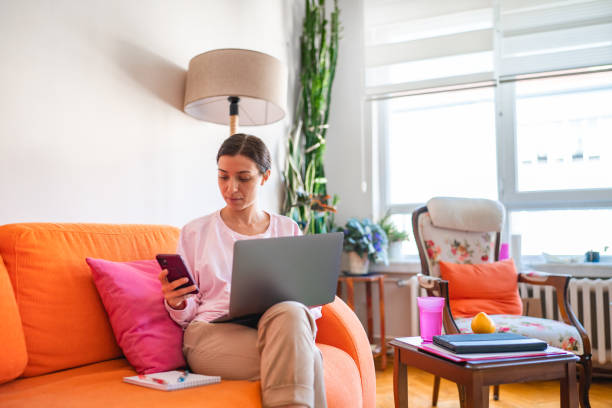istock Young woman working on laptop at home 1442609172