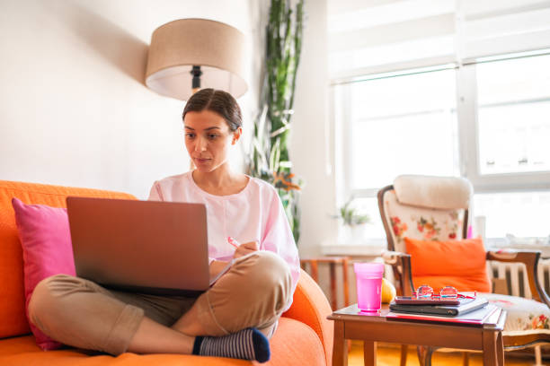 istock Young woman working on laptop at home 1442609229