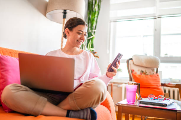 istock Young woman working on laptop at home 1442609345