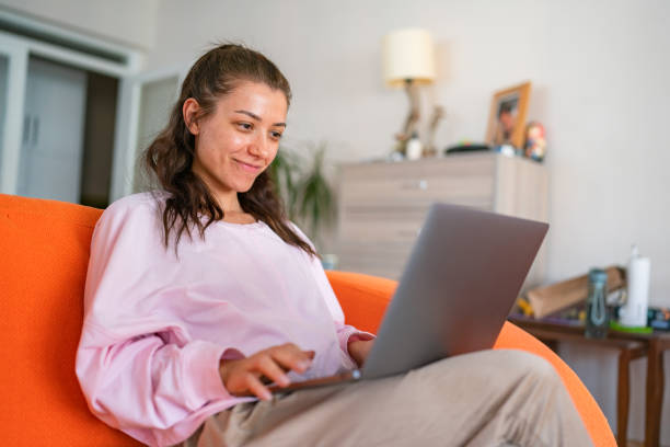istock Young woman working on laptop at home. 1442610350