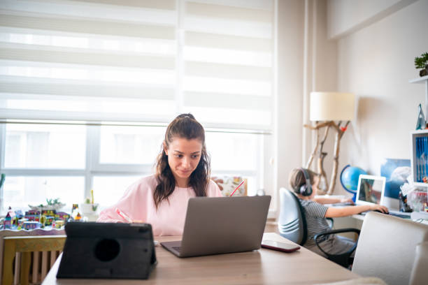 istock Young woman working at home with a kid 1442610454