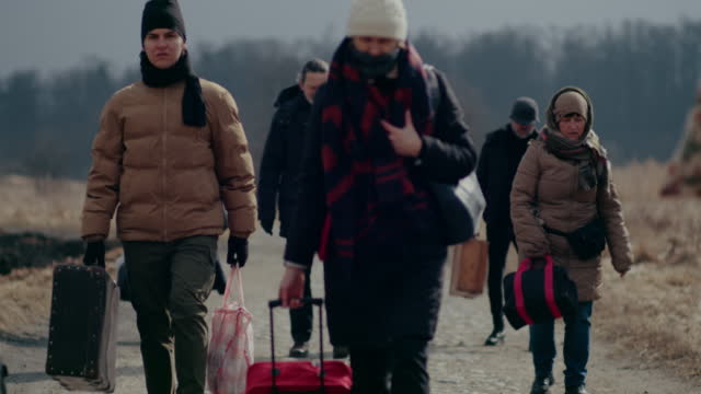 Depressed Refugees Walking While Migrating During War.
