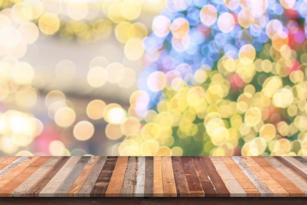 istock Empty wood table top with blur Christmas tree with bokeh light background 1442621626