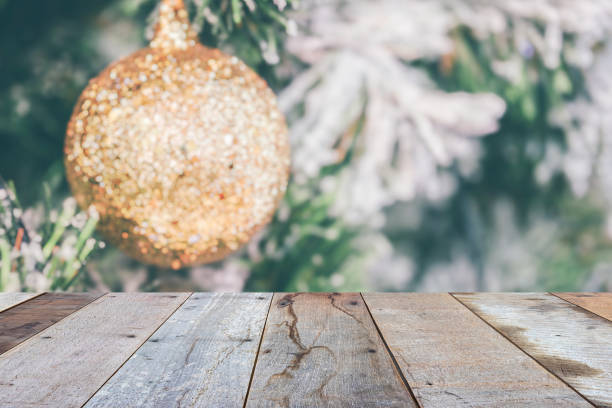 istock Empty wood table top with blur Christmas tree with bokeh light background 1442621628