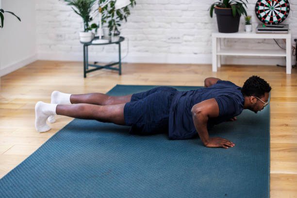 istock An African-American man is doing a home workout by doing push-ups at home. 1442623487