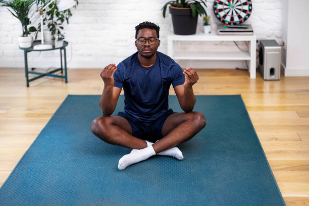 istock A young African man is doing yoga exercises at home. 1442624477