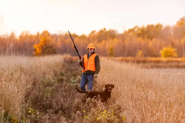 Photo of A teen hunter with his Labrador Retriever