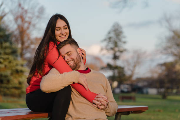 istock romantic couple in the park with sunset 1442626350