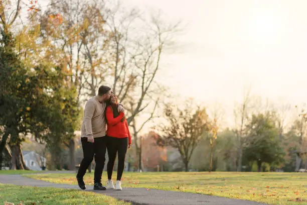 romantic couple in the park with sunset