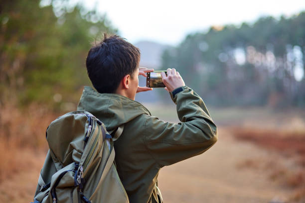 istock Japanese man taking a picture with a smartphone 1442631172