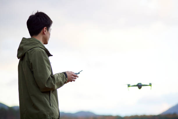 istock Japanese man operating a drone 1442631287