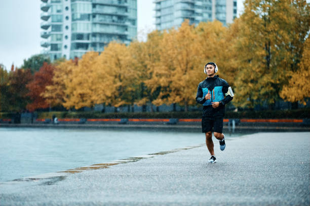istock Determined athlete running while having sports training outdoors during rainy day. 1442635243