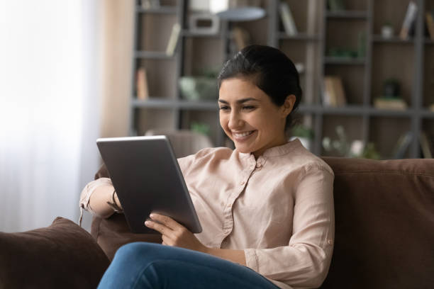 istock Happy young Indian woman using digital tablet. 1442639290