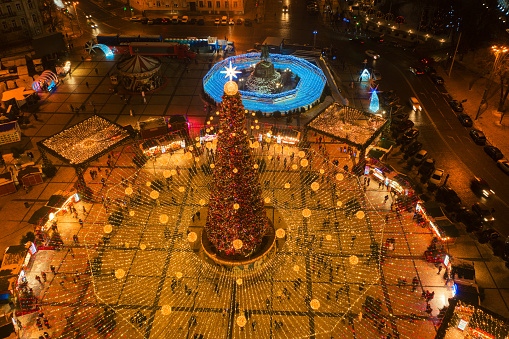 Kyiv, Ukraine January 2, 2022 Aerial top view of beautiful Main Ukraine's New Year tree on Sophia Square in Kyiv. Fairy-tale decorated tree and Christmas market on Sophia Square, Scenic winter evening