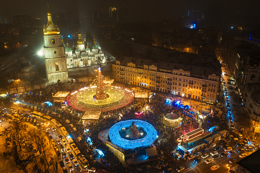 Kyiv, Ukraine January 27, 2022 Aerial top view of beautiful Main Ukraine's New Year tree on Sophia Square in Kyiv. Fairy-tale decorated tree and Christmas market on Sophia Square, Scenic winter evening
