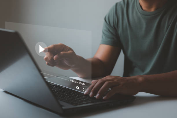 istock Man watching and live streaming window for Video streaming on internet and multimedia technology concept. streaming online on virtual screen, watching video on internet, live concert, show or tutorial 1442646198