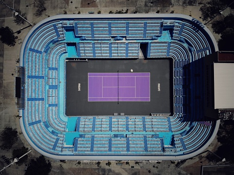 Aerial view of blue tennis courts for sports recreational activity.