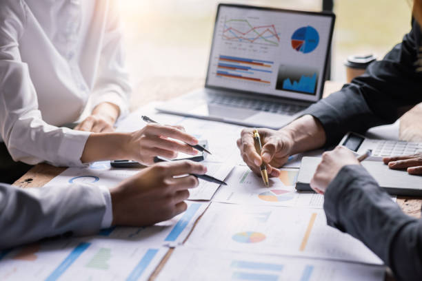 istock diverse coworkers working together in boardroom, brainstorming, discussing and analyzing and planning business strategy. 1442661317