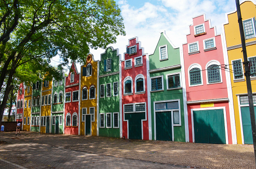 Colorful of dutch buildings or houses with sidewalk and big tree in Holambra City.