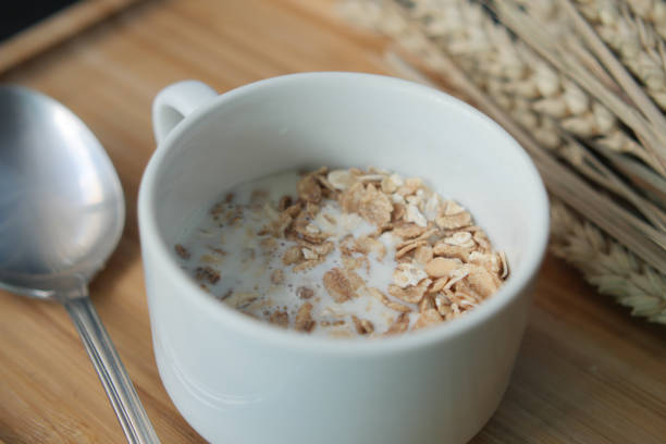 granola musli and milk in a cup on table ,