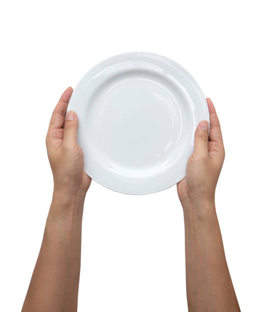 istock Male hands are holding a plate on a white isolated background 1442667353