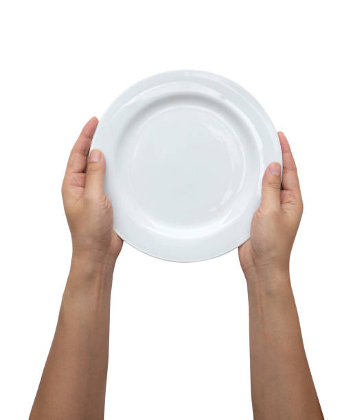 Male hands are holding a plate on a white isolated background stock photo