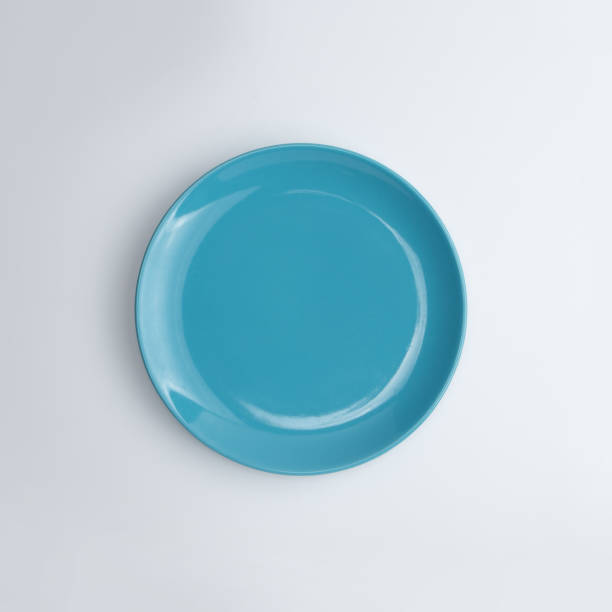 istock Top view of empty white plate isolated on white background 1442667361