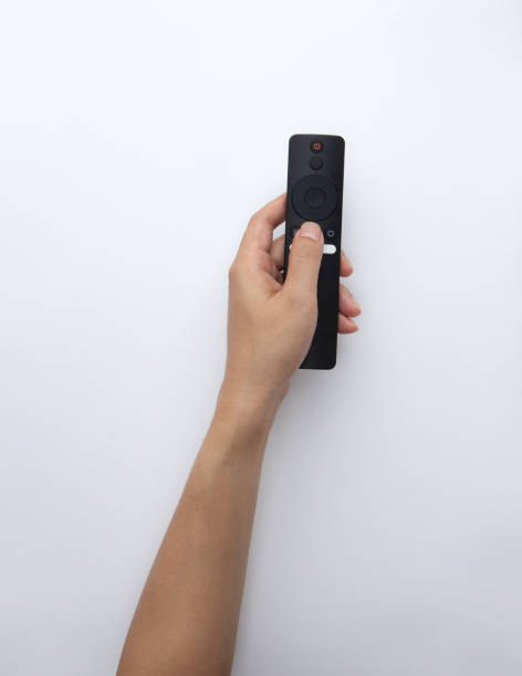 istock Hand holding a remote control isolated on white 1442667386