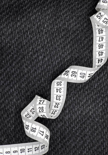 istock white measuring tape on black fabric background 1442675515