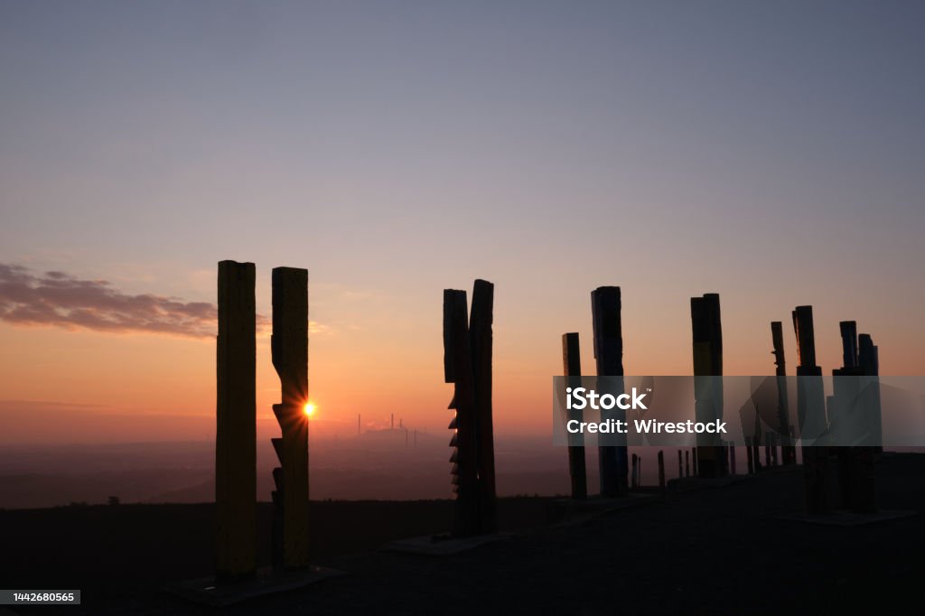 Railway steles as industrial heritage and landmark on the Haniel slag heap in Oberhausen Railway steles as industrial heritage and landmark on the Haniel slag heap in Oberhausen. Fantastic view of the Ruhr region at sunrise. Architectural Stele Stock Photo