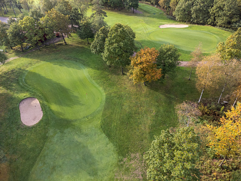 Aerial view of a golf cart with fairways, bunkers and putting greens. Photography taken from above with a drone in Partille in Sweden. Copy space.