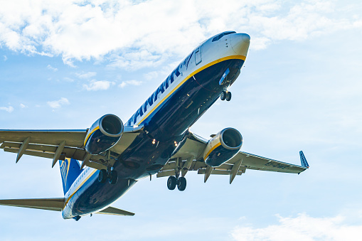 Barcelona, Spain – September 27, 2021: А white and blue Ryanair aircraft with landing gear ready to land at Barcelona airport in Spain on September 27, 2021