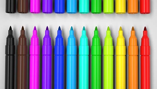 A closeup of colorful markers isolated on white background.