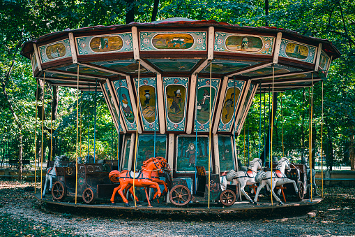 Abandoned horse carousel in a park.
