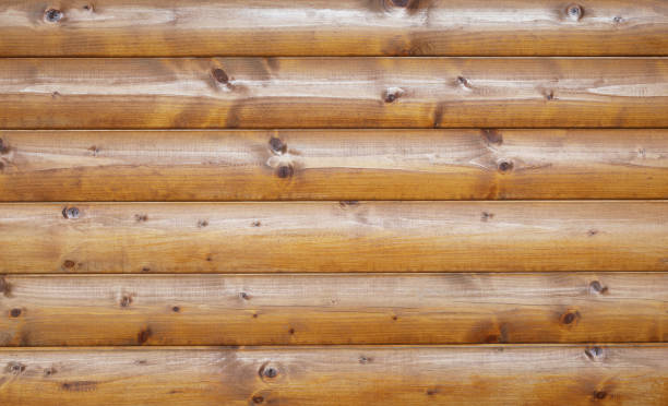 Wooden wall assembled of beams or logs. Natural building concept. Brown background nature idea This is an old wooden wall assembled of beams or logs. gnarly wood texture stock pictures, royalty-free photos & images