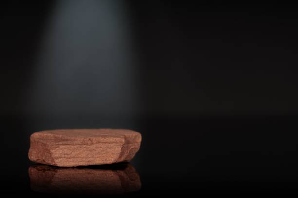 istock Stone podium for packaging and cosmetic presentation on black background. 1442685016