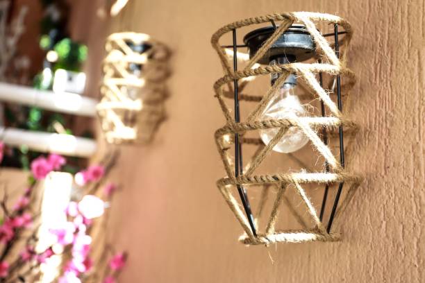 istock Soho-style macrame wall lamp against a peach-colored wall. 1442685582