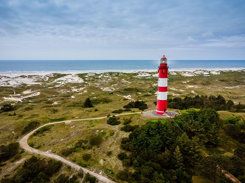 A lighthouse on the Island Amrum in Northern Germany with a seascape view in the background