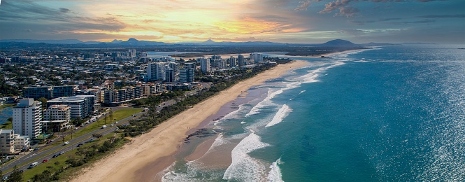 A breathtaking aerial view of the ocean and the city at the sunset in Queensland, Australia