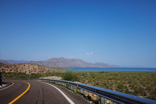 A landscape view of winding road in Baja California Sur, Mexico, near sea, during daytime