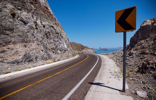 A landscape view of winding road in Baja California Sur, Mexico, near sea, during daytime