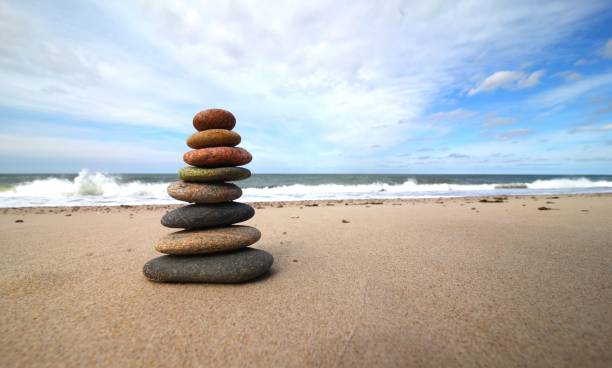istock Stacked pebbles on the beach representing peace with rock balancing concept 1442686792