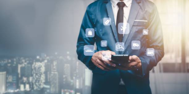 istock Shopper using his phone with floating digital icons 1442688369