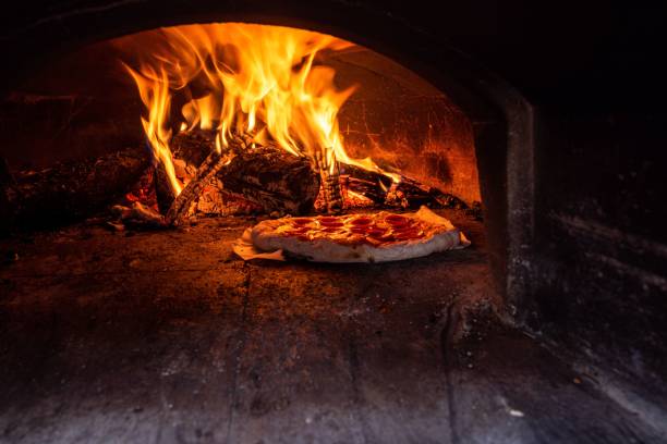 istock Italian pizza in a traditional wood-fired stone oven 1442689794