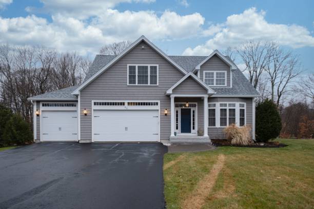 istock Gray-walled suburban house with white asphalt driveway 1442689844